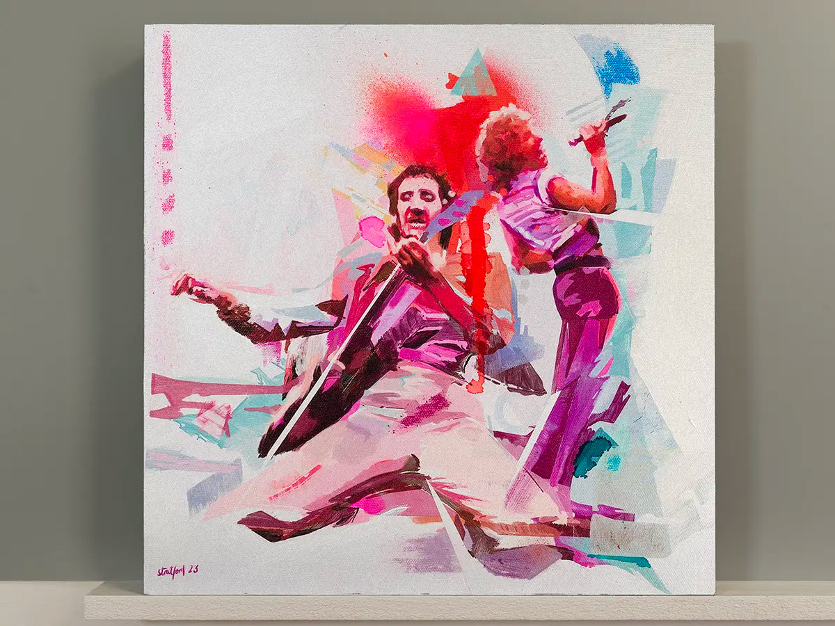 A square canvas painting of the who performing live, rendered in a vibrant abstract style with pink, purple, red, and blue brushstrokes on a white background, displayed on a shelf against a gray wall.