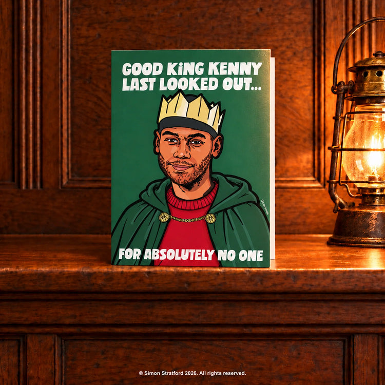King Kenny Christmas card in a crown and cloak: Good King Kenny last looked out… for absolutely no one. Standing slightly open on a wooden mantelpiece beside a glowing antique lamp.