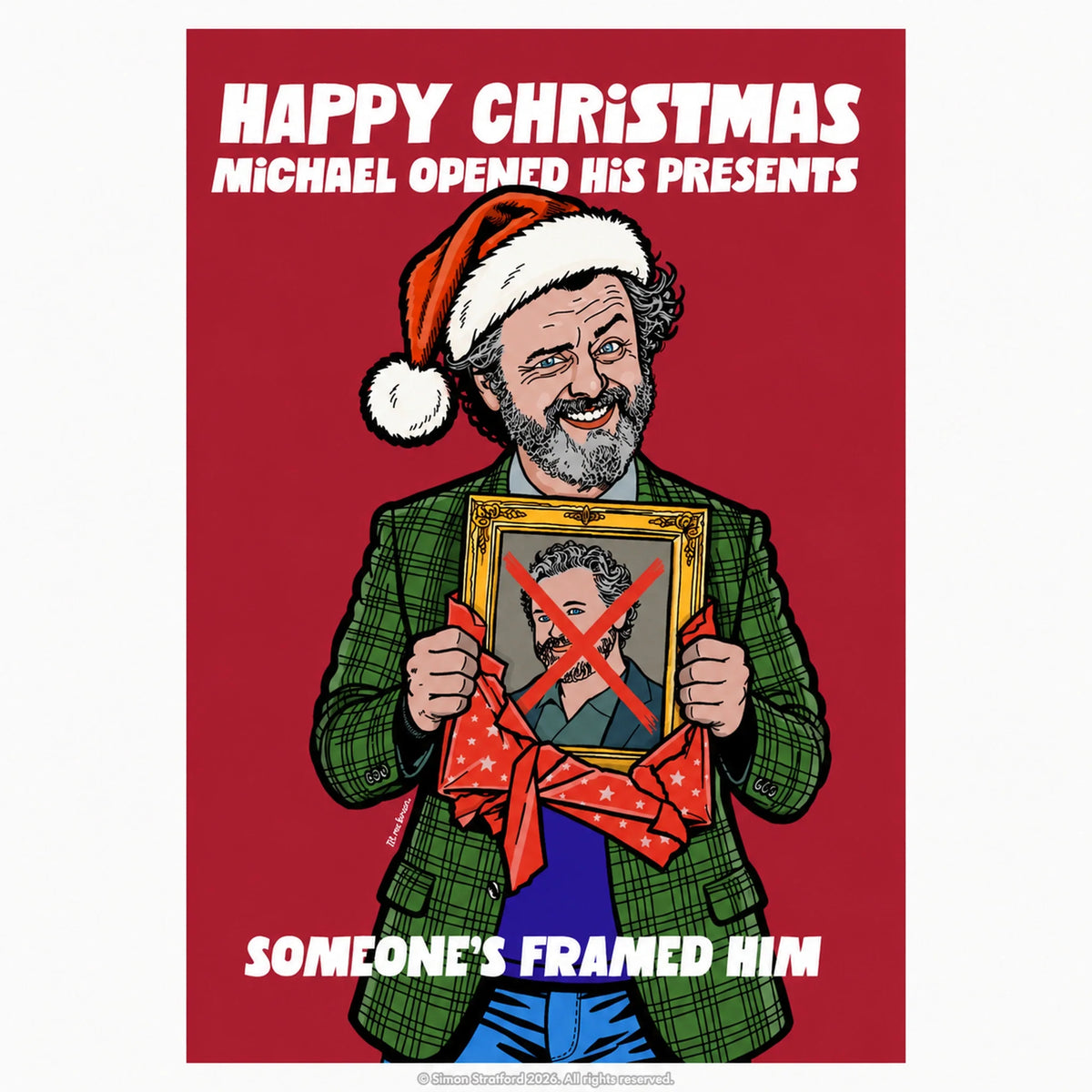 Michael Sheen Christmas card showing him in a Santa hat holding a framed portrait with a red X: Someone’s framed him.