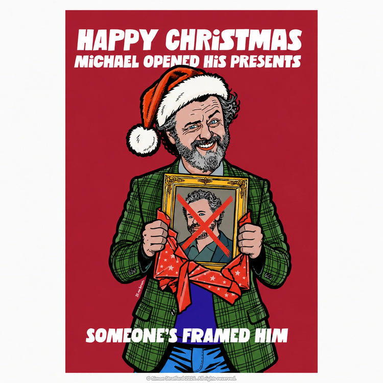 Michael Sheen Christmas card showing him in a Santa hat holding a framed portrait with a red X: Someone’s framed him.