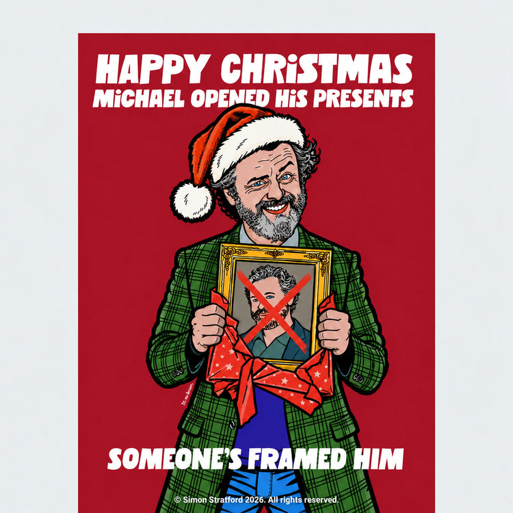 Close-up of Michael Sheen Celebrity Traitors Season Two Christmas card showing him in a Santa hat holding a framed portrait with a red X: Someone’s framed him.